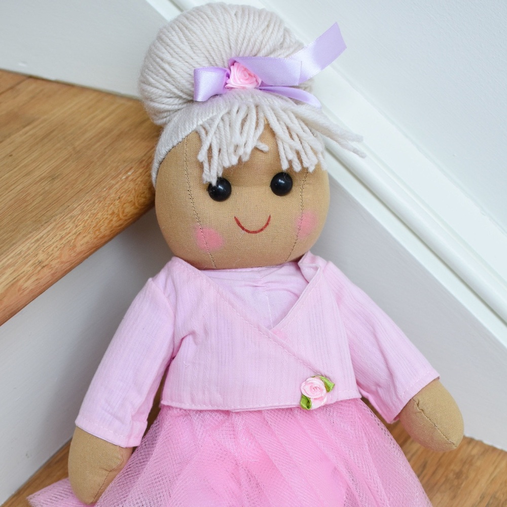 A traditional, soft-bodied rag doll dressed as a ballerina