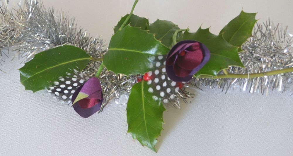 flower and feather deecoration on a pine branch