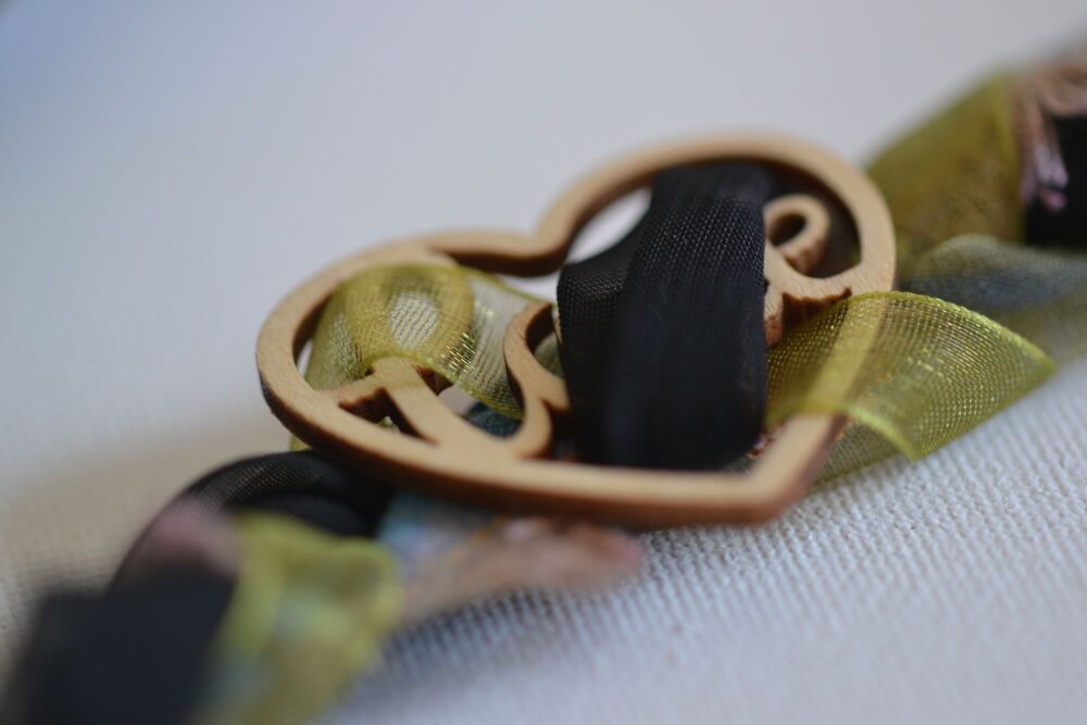 necklace detail wooden heart on green and black ribbon