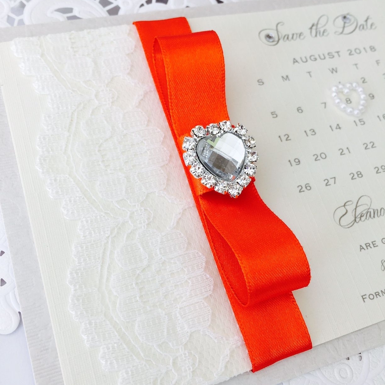 Save the date wedding calendar with orange ribbon and a crystal heart