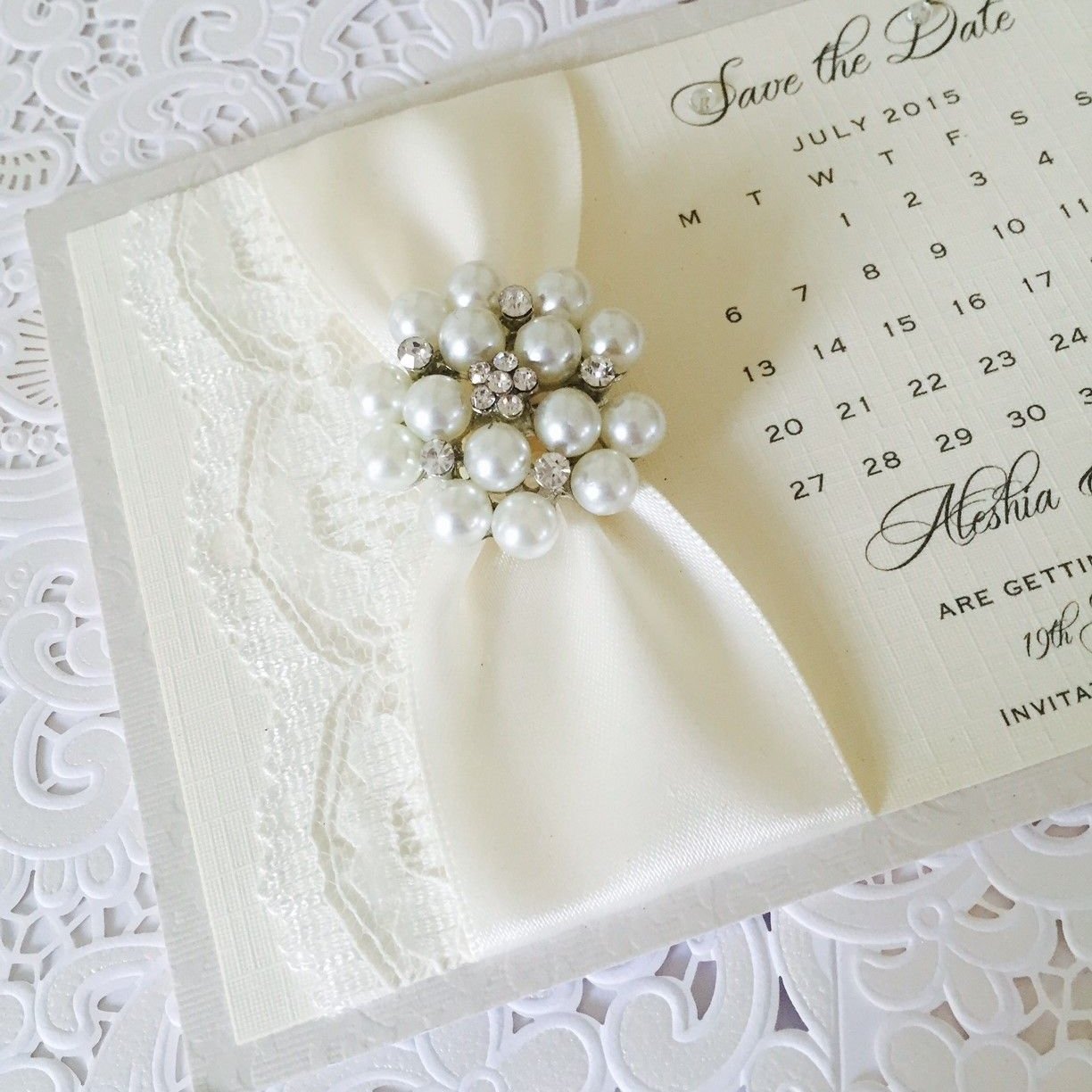 Vintage style save the date card with ivory lace and brooch