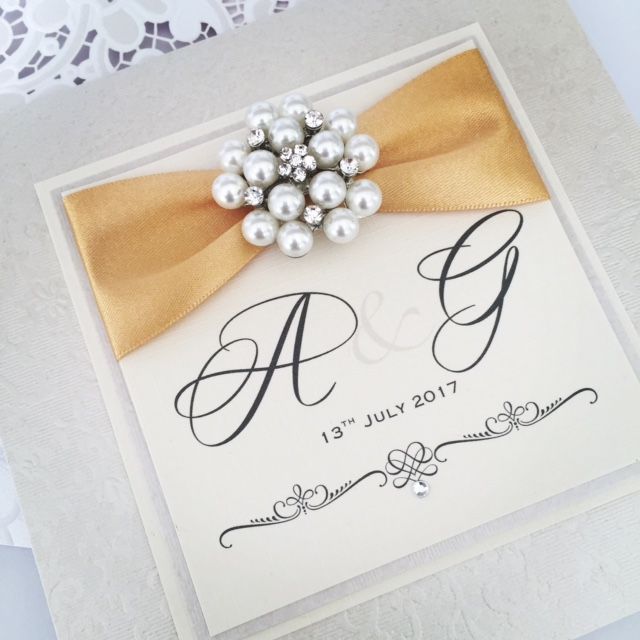 wedding invitation with monogram initials decorated with gold ribbon