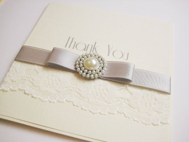 Lace thank you wedding card with silver ribbon and brooch