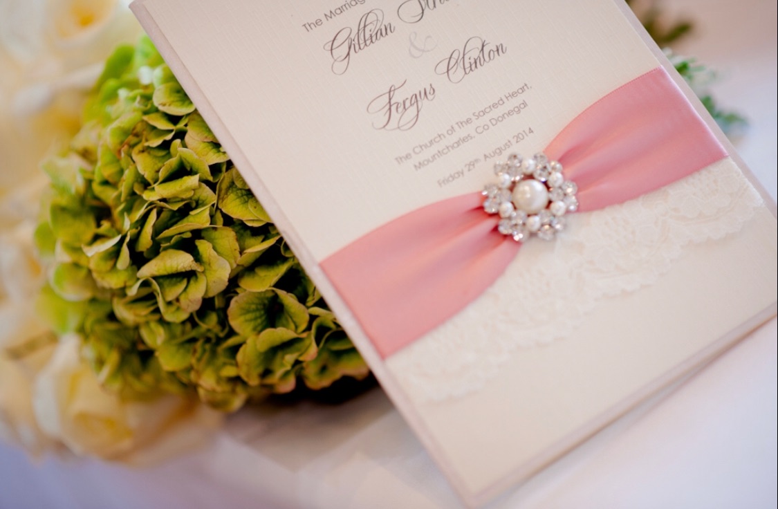 Wedding order of service book with ribbon and brooch