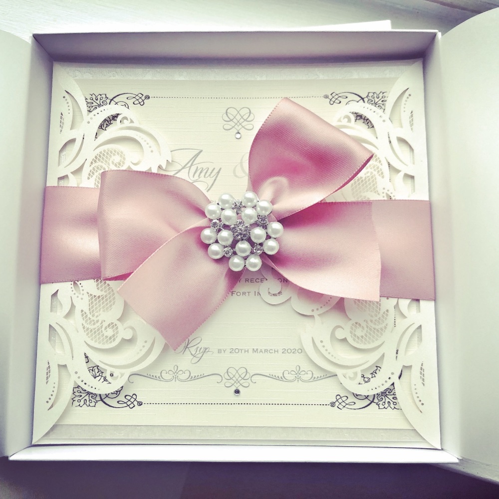 Laser Cut Invitation Sample with Large Bow and Pearl Brooch