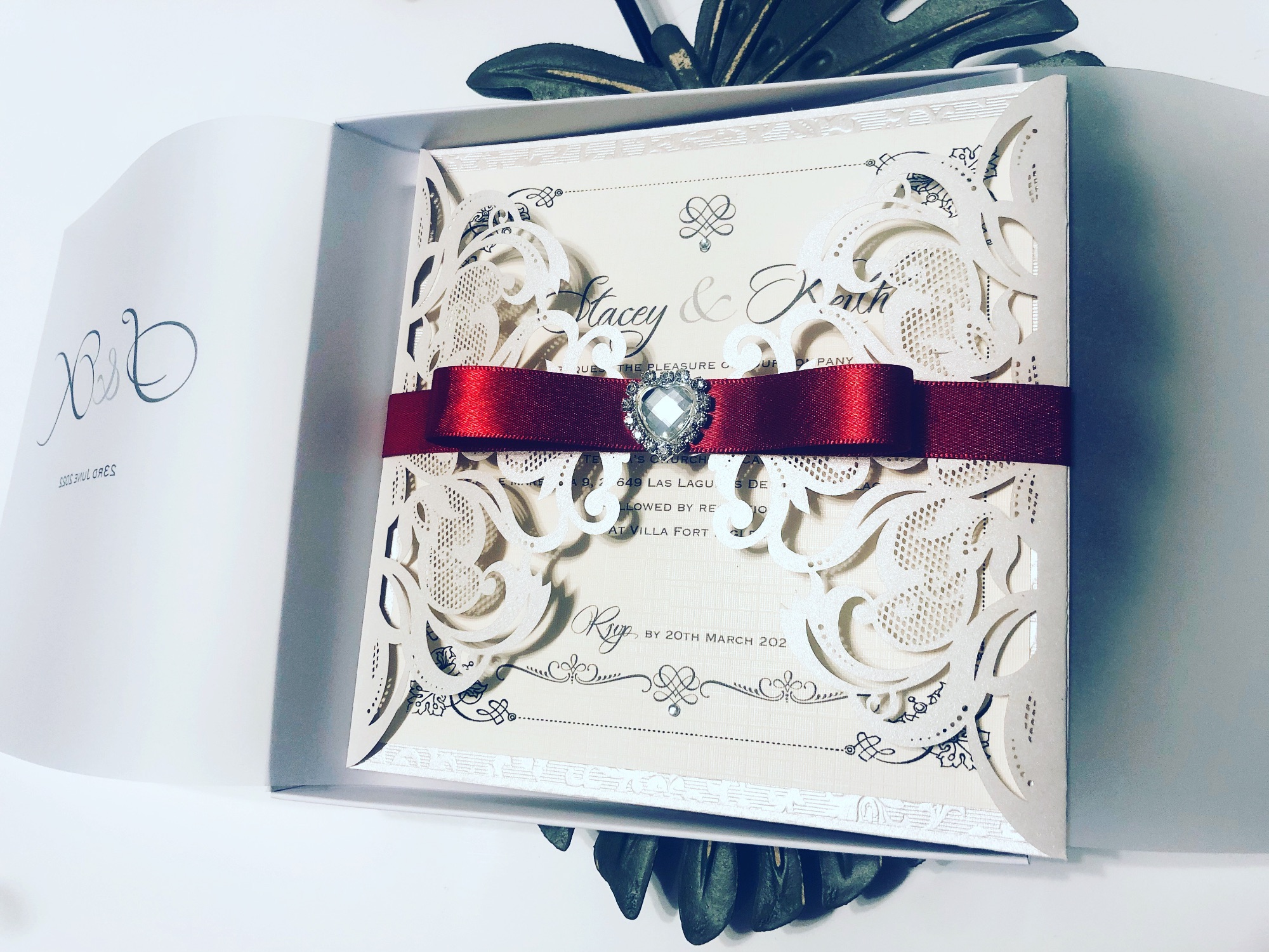 Laser cut invitation with red bow