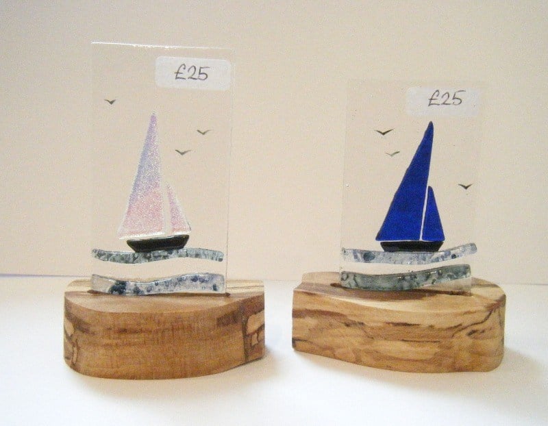 glass boats on wooden stands