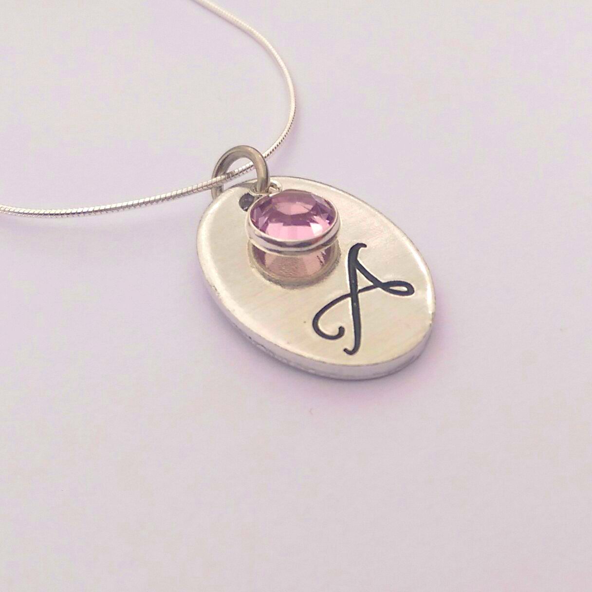 Hand stamped personalised oval initial necklace with swarovski crystal