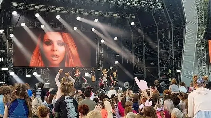Little Mix performing live on stage at Lincolnshire Showground concert with large crowd