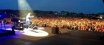 Elton John performing live on stage at Lincolnshire Showground with large crowd â full concert cleaning and waste management services
