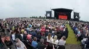 Festival crowd and stage with live performance at Lincolnshire Showground â professional cleaning and litter picking services provided
