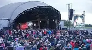 Outdoor music concert at Lincolnshire Showground with large audience