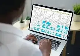 Practice manager reviewing compliance data on a laptop for Gainsborough GP surgery cleaning