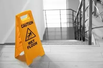 Spotless stairwell landing in Newark with mop bucket and wet floor sign after communal area cleaning by Clean Sweep Commercial
