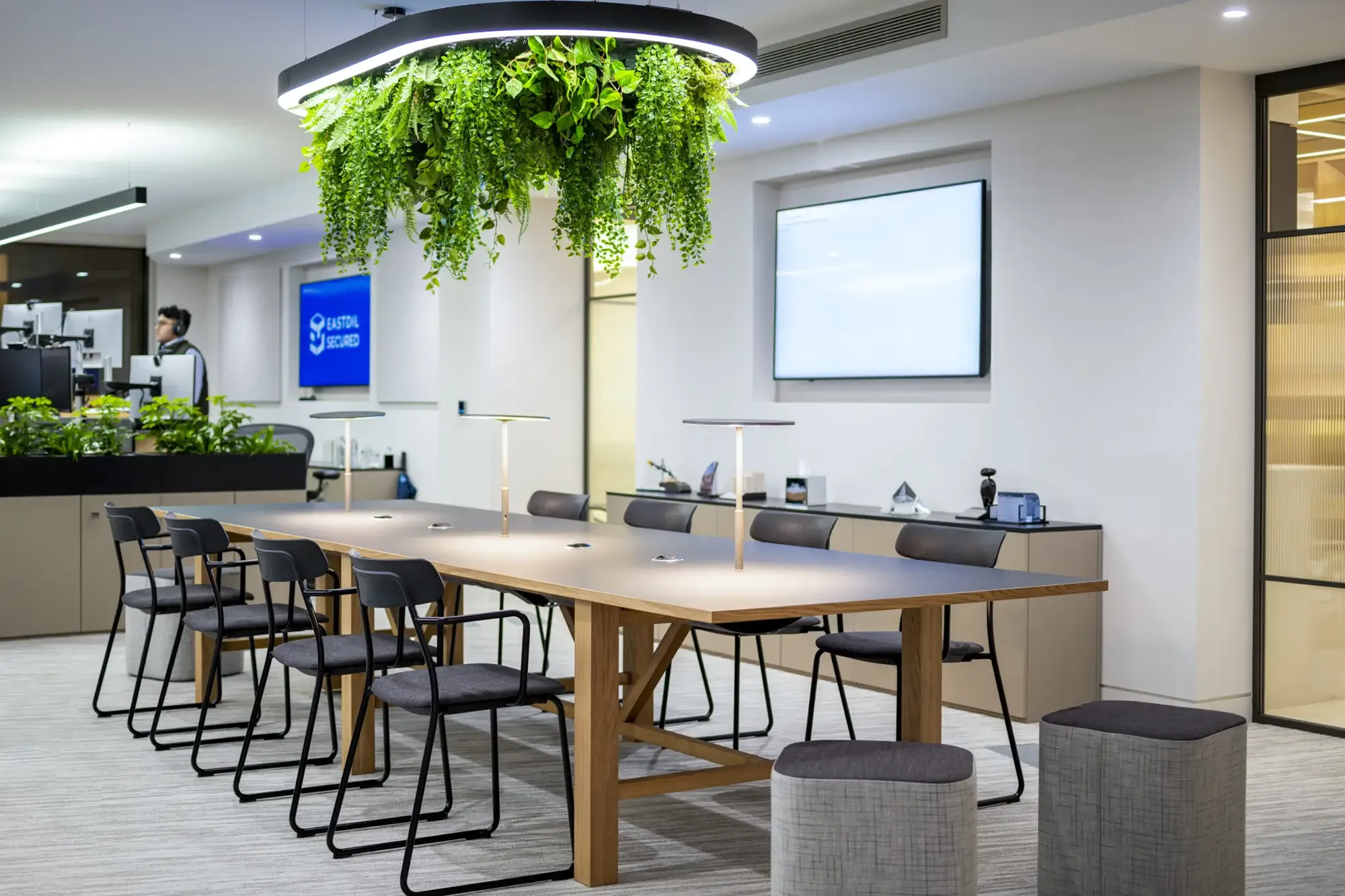 Clean, modern Hykeham office workspace with meeting table and indoor greenery