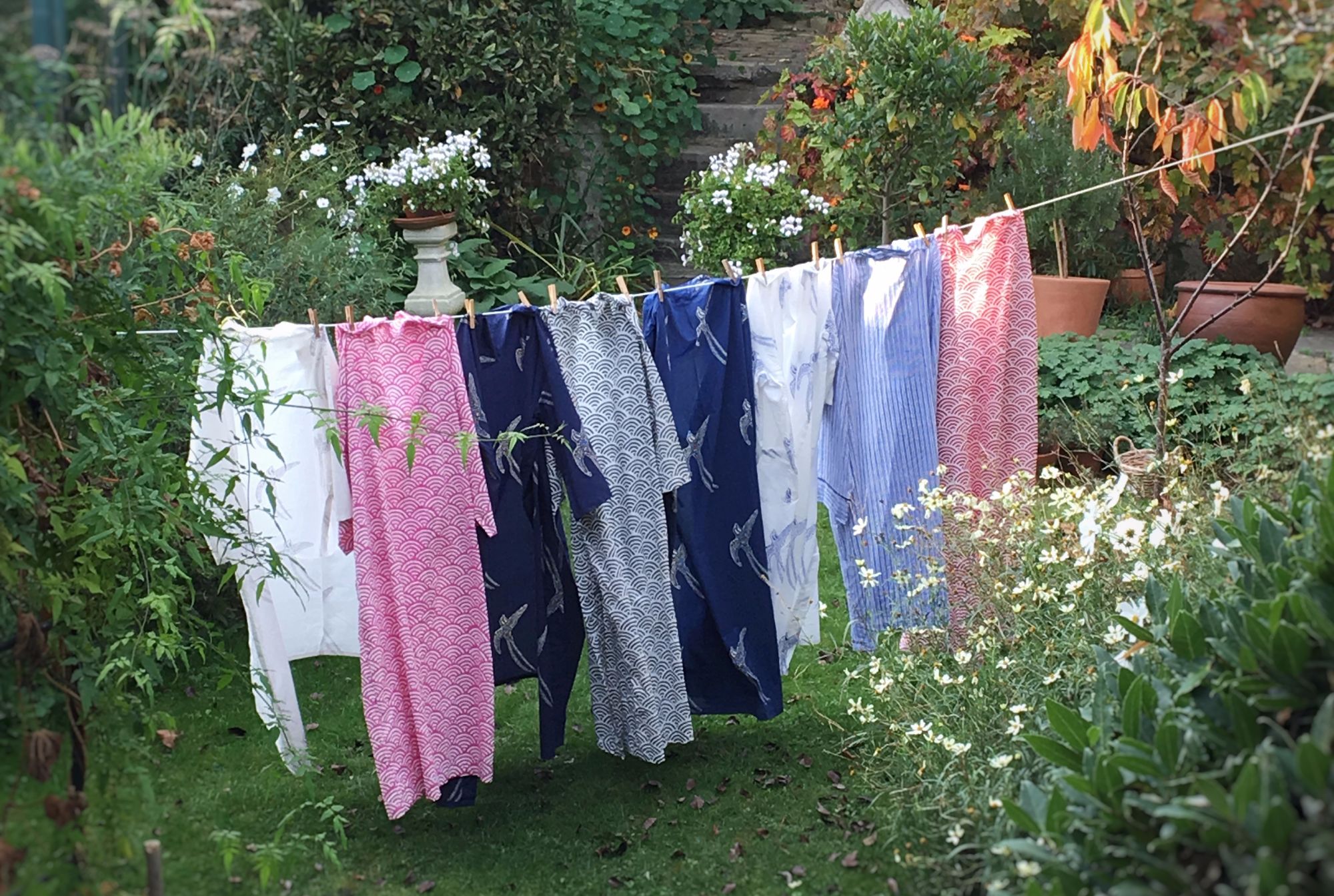 kimonos hung up on a washing line in the gardne