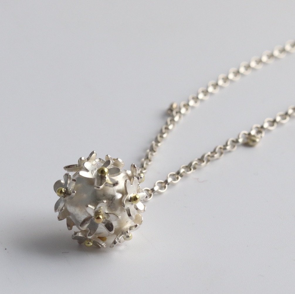 Silver flower bomb necklace with gold detail