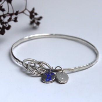 Silver Bangle with Beaten Finish and Flower Stampings with Two Nugget Charms and Three Silver Loops