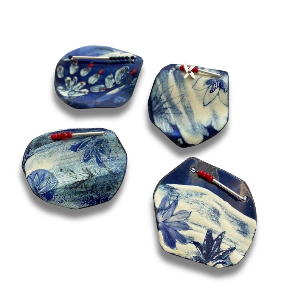 Blue and White Enamelled Brooches Inspired by Pieces of Broken Pottery