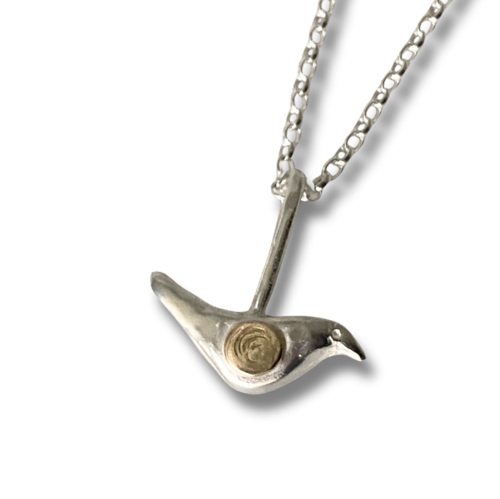 Bird with Gold on Chain.