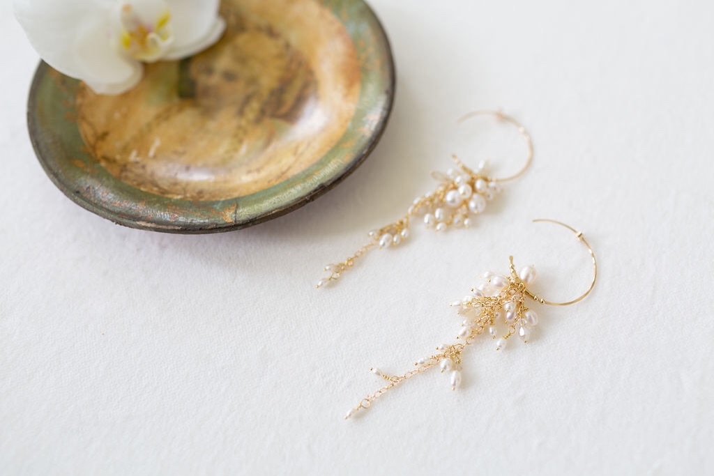 Statement gold and freshwater pearl bridal hoop earrings with chandelier pearls suspended from the hoops