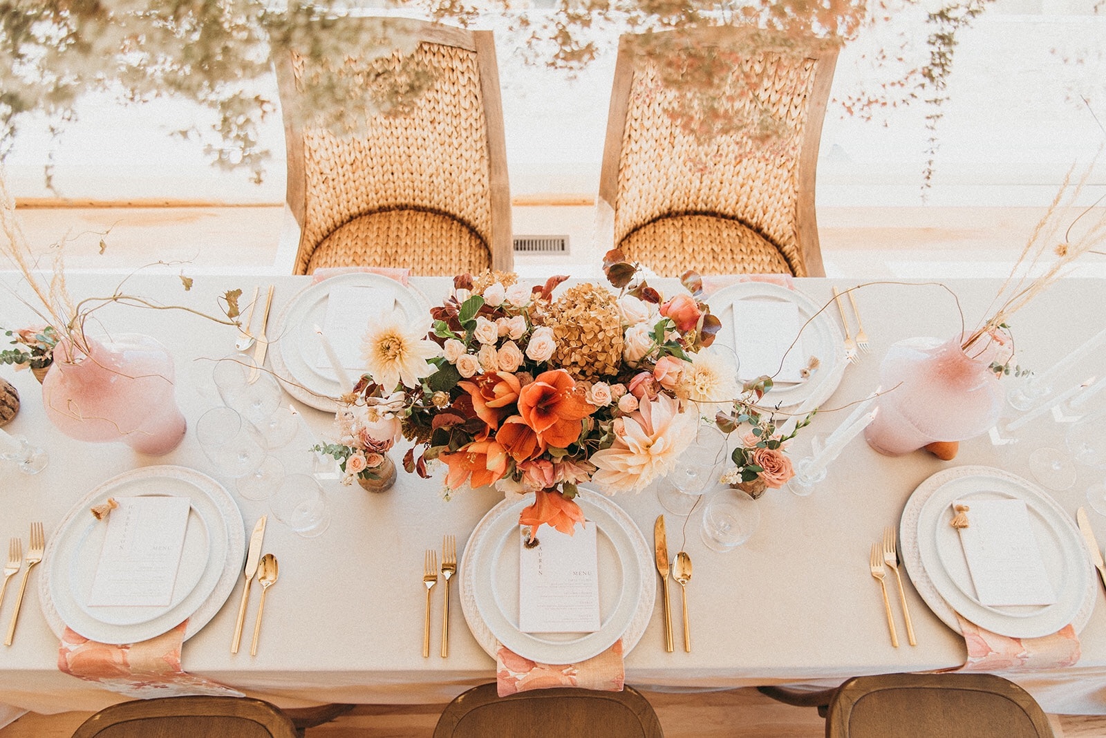 An Autumn wedding tablescape in shades of gold, burnt orange and rust