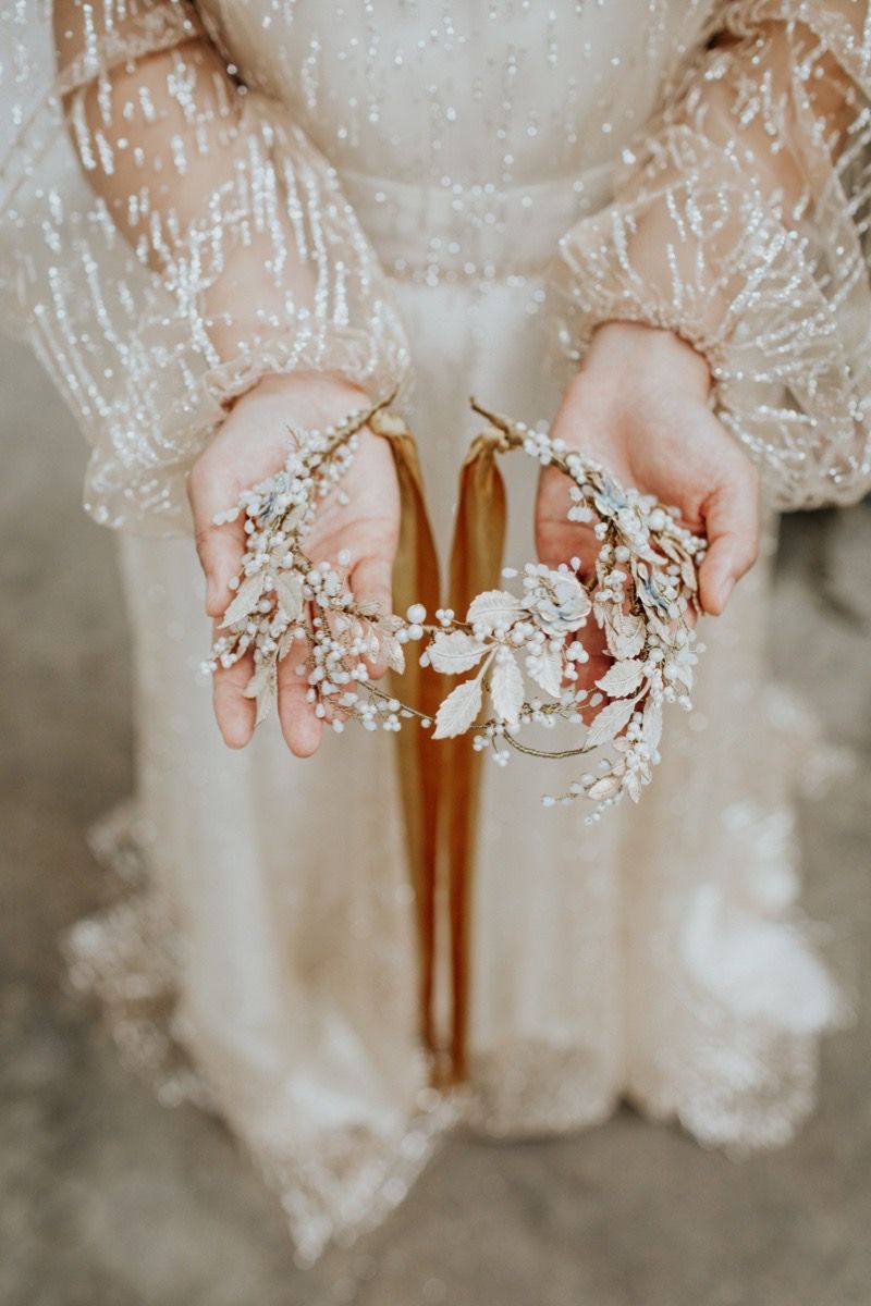 A statement bridal crown made from glass pearls, crystals and pale gold roses and leaves