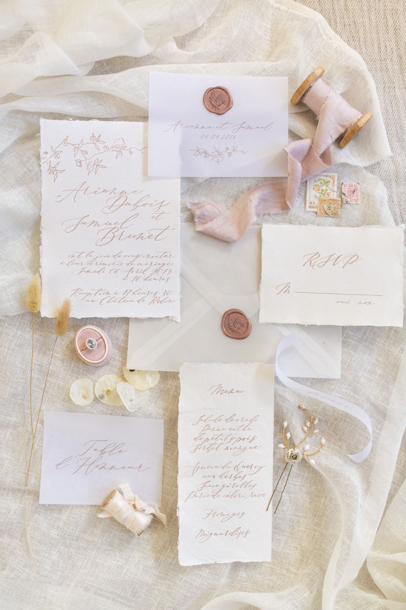Flat lay image of wedding stationery wedding hair pins and ring captured by Anneli Marinovich