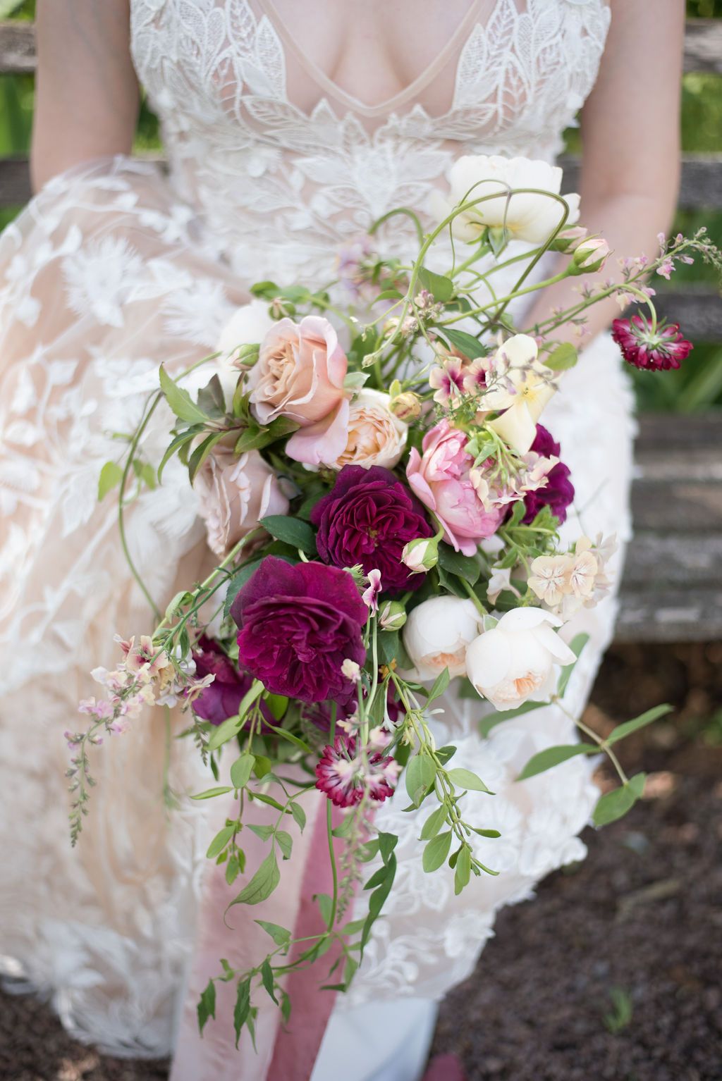 Bridal bouquet with wine, raspberry and blush roses by Clementine Moon Florist