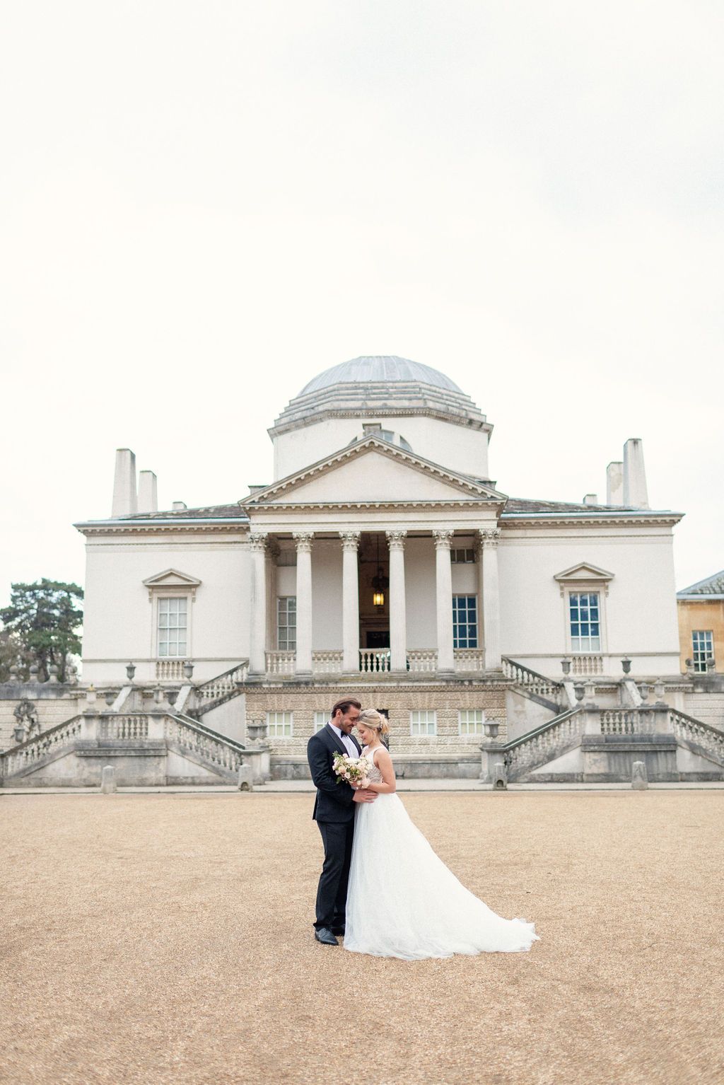 Bride and Groom stand in front of Chiswick House