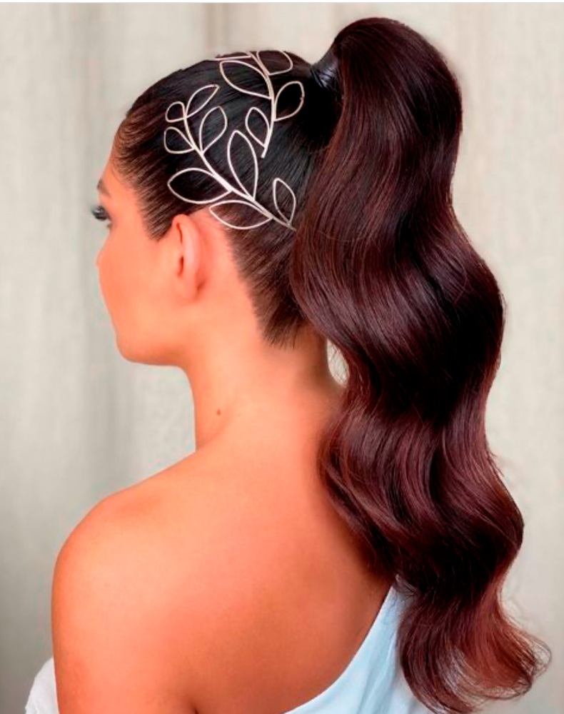 Bridal hair style created by Kasia Fortuna with a high ponytail and two silver leaf headpieces 