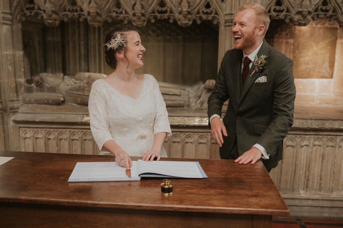 Bride wearing vintage lace wedding dress and vintage pearl wedding headpiece