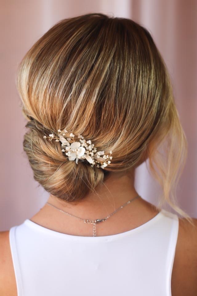 White floral Anemone bridal hair comb styled in a low elegant bun by stylist Moira Borg