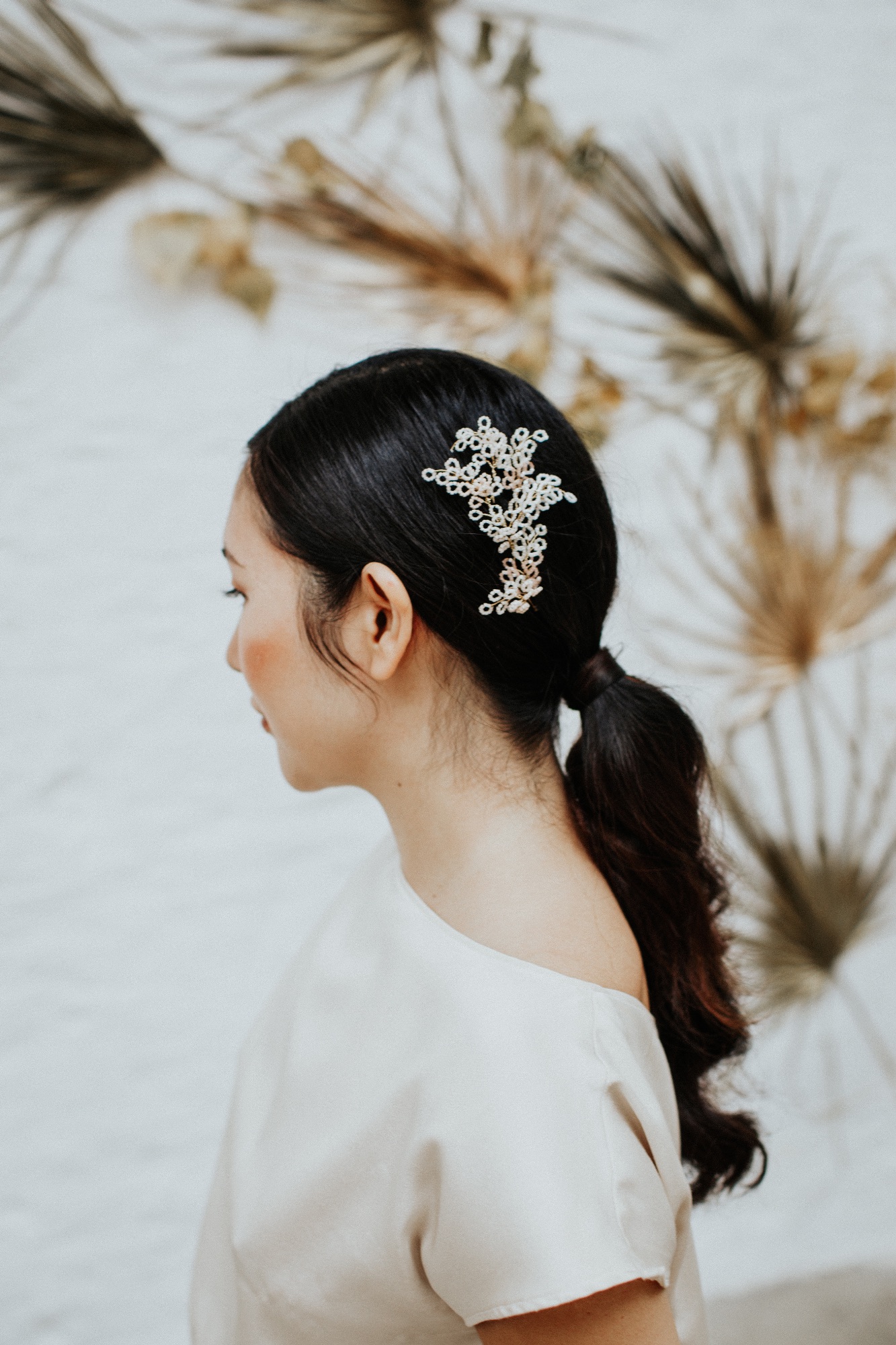Willow delicate blossom wedding hair pins worn with a low ponytail