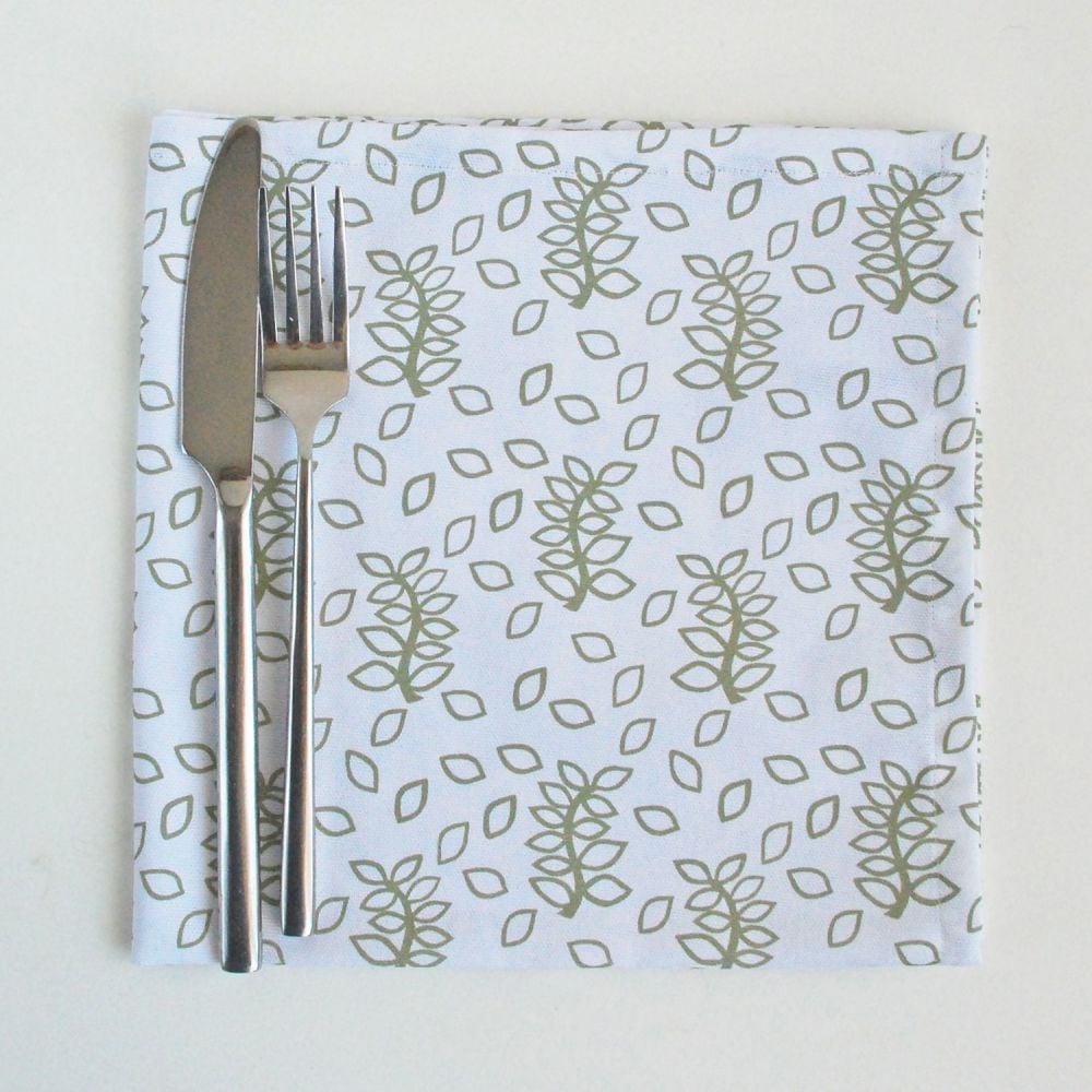 White napkins sage green leaves design