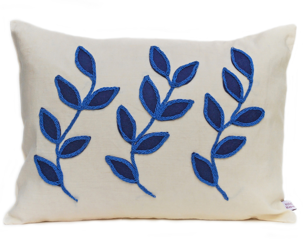 Linen cushion with blue leaf design