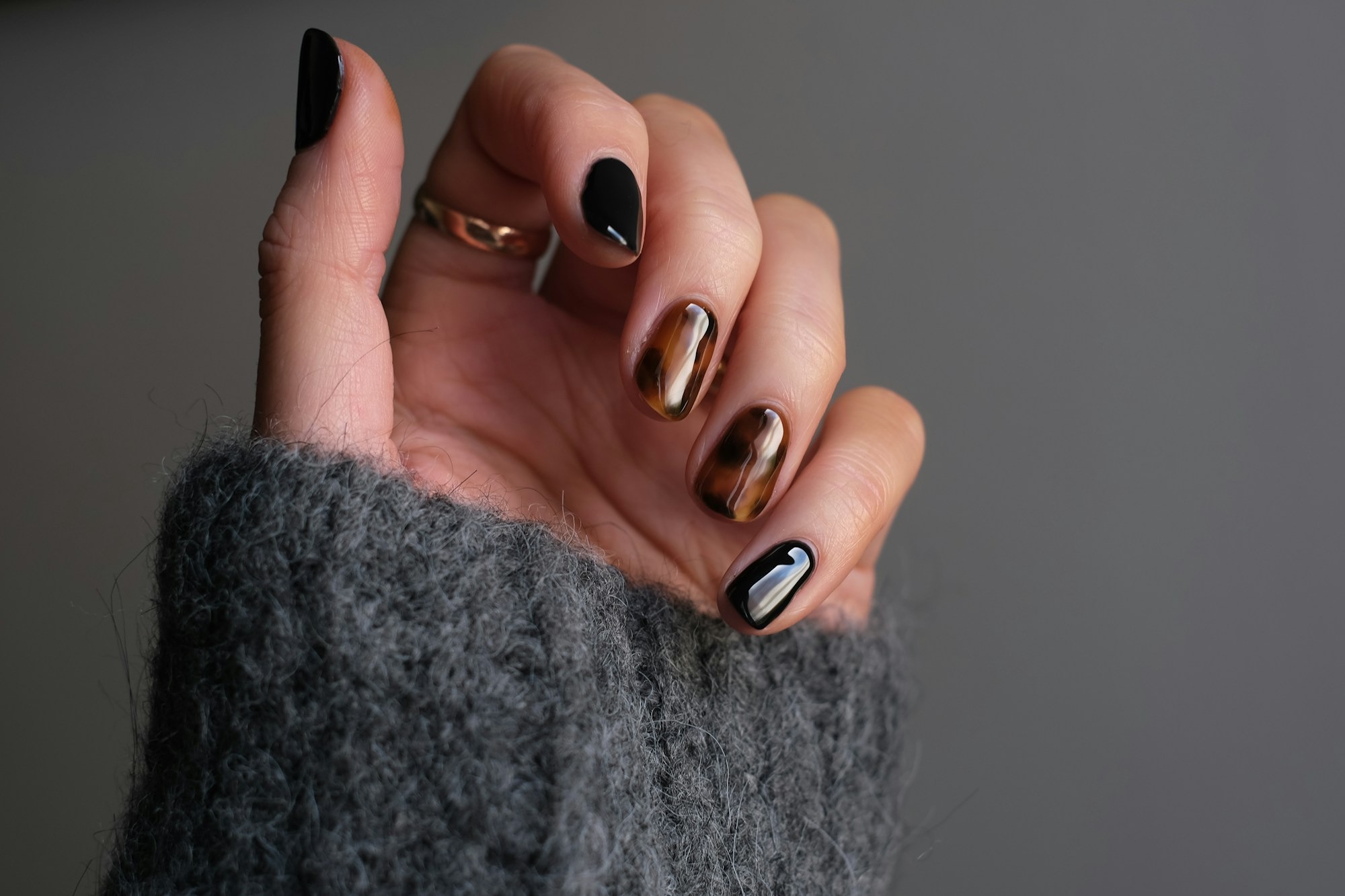 person-wearing-silver-ring-with-black-manicure-KZKbGgQPCtU.jpg