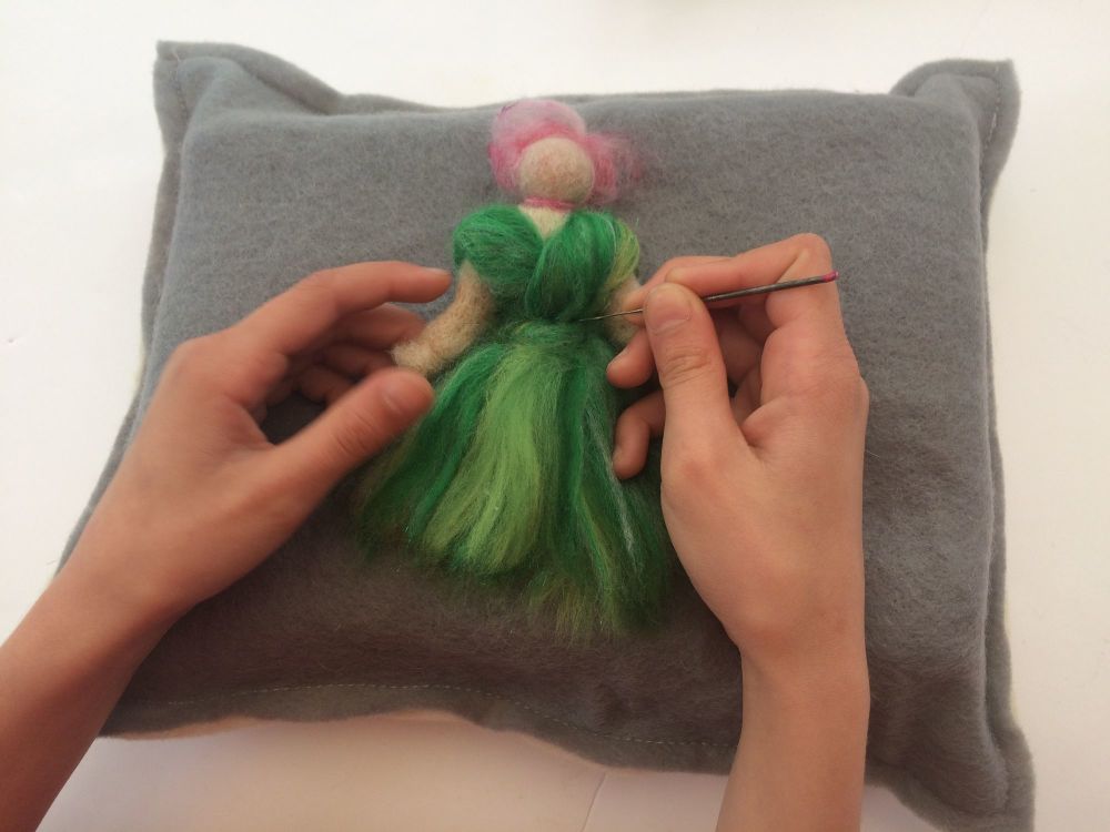 needle felting heidifeathers on mat wih needle fairy