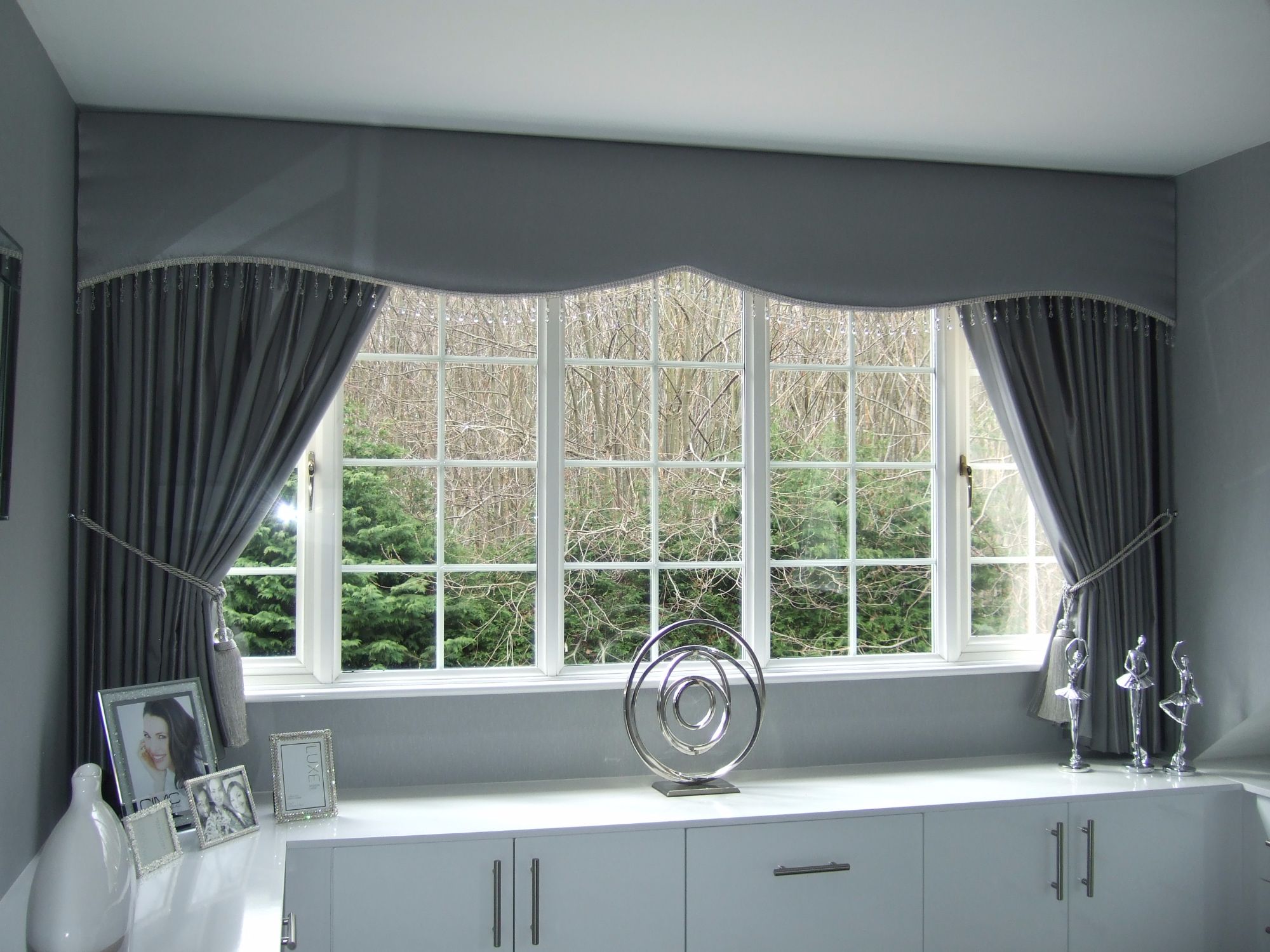 Shaped satin pelmet and curtains with crystal trim