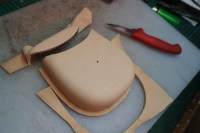 14) The surplus leather is cut away to reveal the front shaped of the pouch
