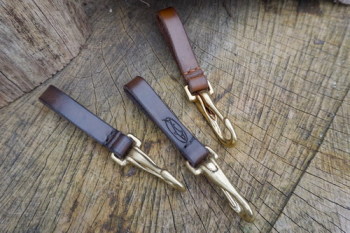 Leather-belt loops with brass bridle hooks grouped together hand stitched b