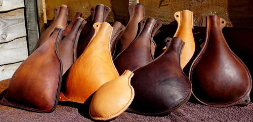 leather-handmade leather bottles drying in the sun by Shark Designs Leather