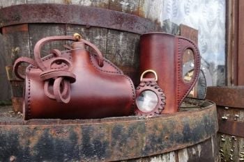 leather handmade bottle with solar lens and leather tankard made by beaver