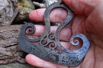 fire steel held by Beaver Bushcraft of thors viking hammer with triskele