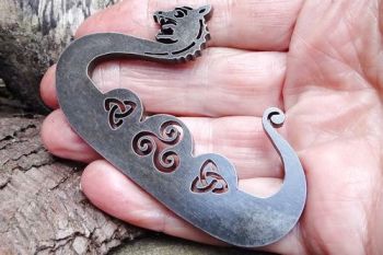 Fire steel showing the smaller dragon held in hand by beaver bushcraft