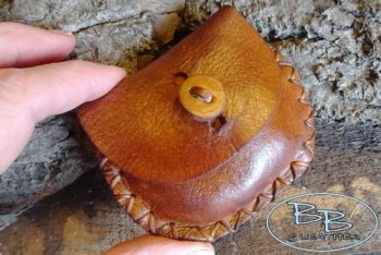 Vintage leather mini pocket pouch held by beaver bushcraft