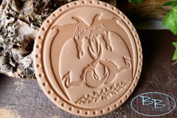 Leather patch embracing dragons made by beaver bushcraft