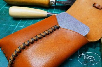Leather pocket pouch with small silver tin by beaver bushcraft