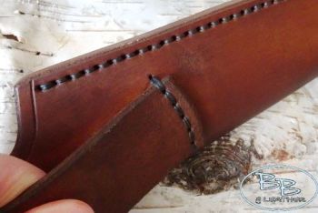 Leather sheath with the belt loop on show by beaver bushcarft