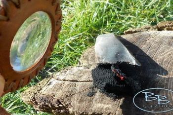 A leather solar pendant in action for beaver bushcraft with char cloth